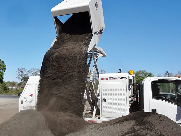 Starfire S-4c elevated hopper dumping a heavy debris load