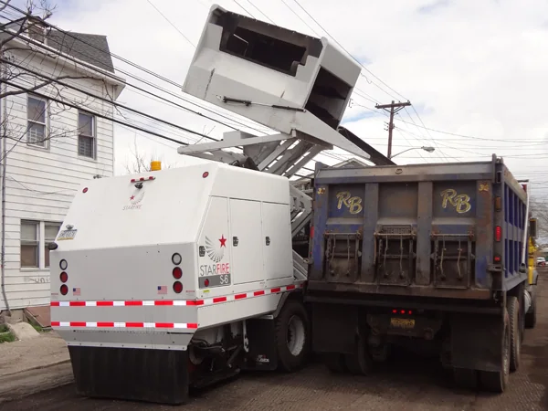 Starfire S-6t raised hopper dumping into a truck